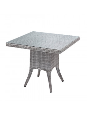 Four seater grey rattan garden table at an angle with white background