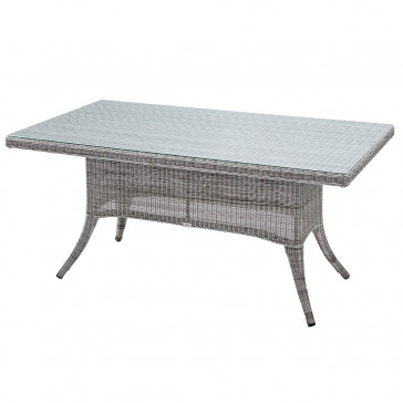 Six seater grey rattan garden table on an angle in front of stone wall