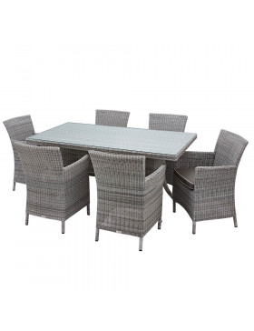 Six seater grey rattan garden table and chairs in front of stone wall