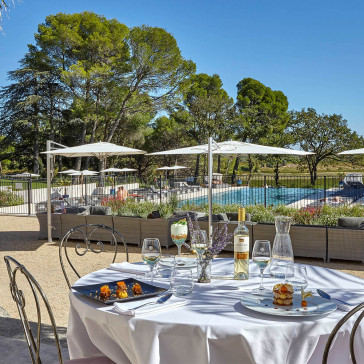 Bistro dining set table and chairs on terrace infront of pool