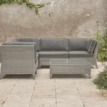 Oceane modular set showing three corners and two middle seats and a coffee table French grey rattan on Southern French terrace.