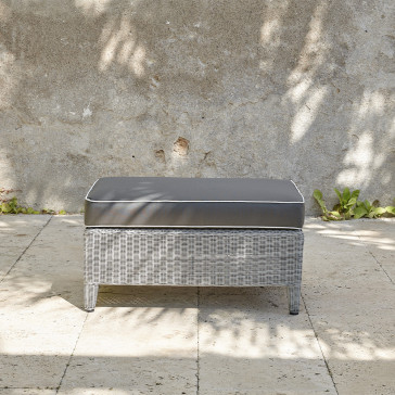 Oceane rattan garden foot stool with cushion on a southern French terrace close up view