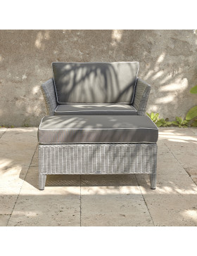 Oceane rattan garden foot stool and cushion with an armchair on a southern French terrace front view