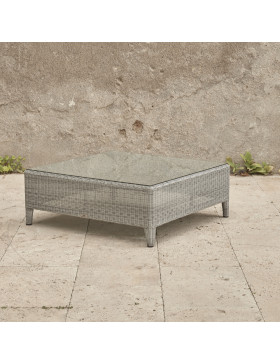 Oceane garden corner coffee table with tempered glass top French grey rattan pictured at an angle on a Southern French terrace.