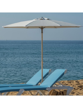 octagonal shaped parasol fully opened on french beach next to blue ocean