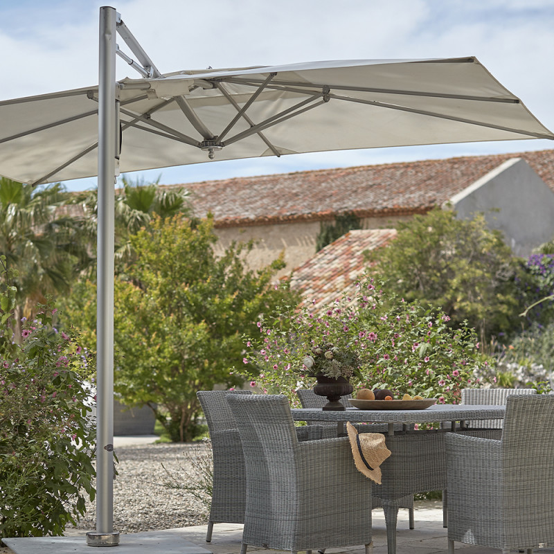 Tucci parasol in a garden giving shade to a dining table and chairs