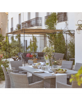 Eight seater table and chairs. French Grey rattan. On a French terrace beside corner lounge set