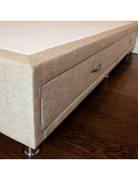 Divan bed base with drawers upholstered in an oatmeal furniture fabric pictured on a wooden floor